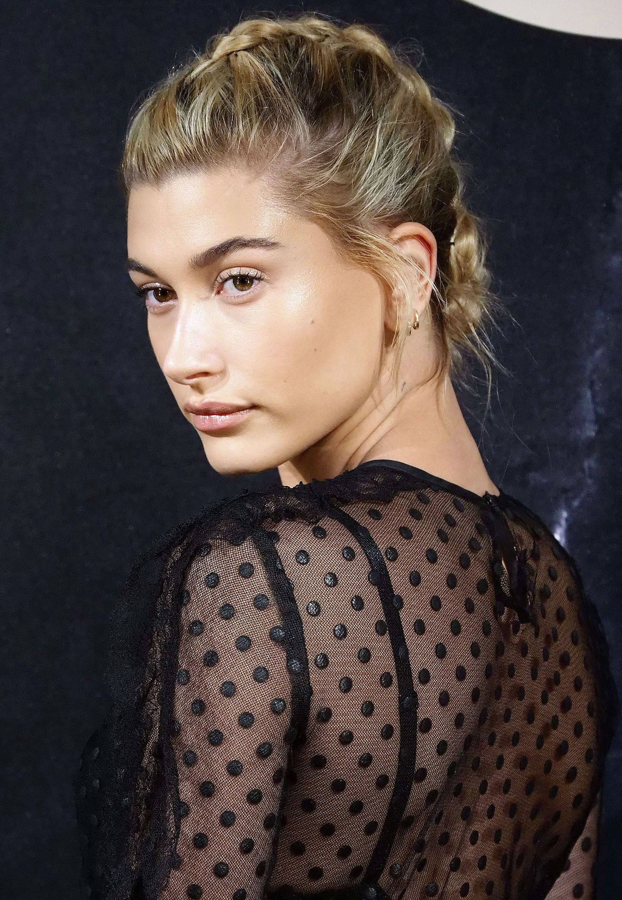 side view of hailey baldwin with blonde hair in french plait