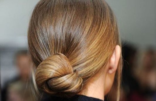 back view of blonde hair in low knotted bun