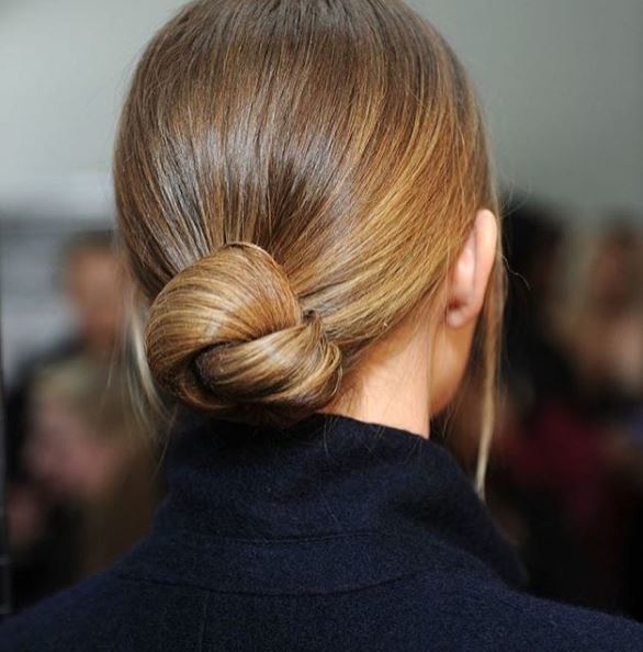 back view of blonde hair in low knotted bun