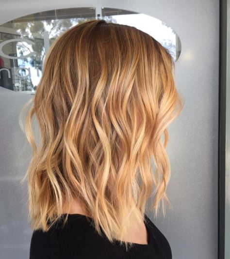 Spiced cider hair: Side view of strawberry blonde balayage shoulder length wavy hair