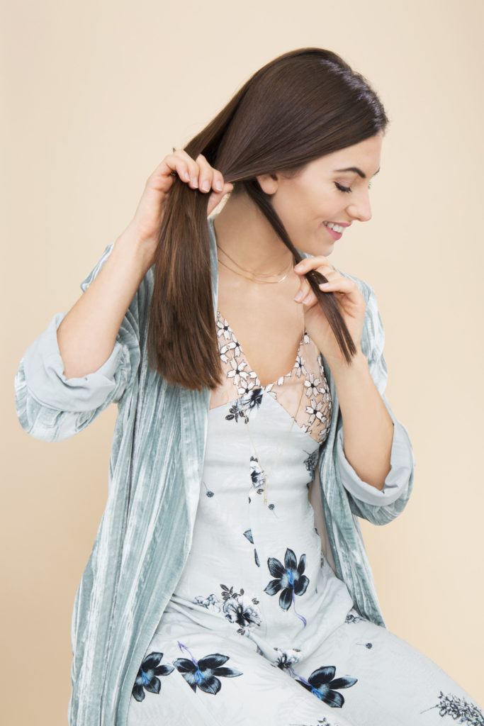 Fishtail plait brunette girl looking to the side braiding her hair