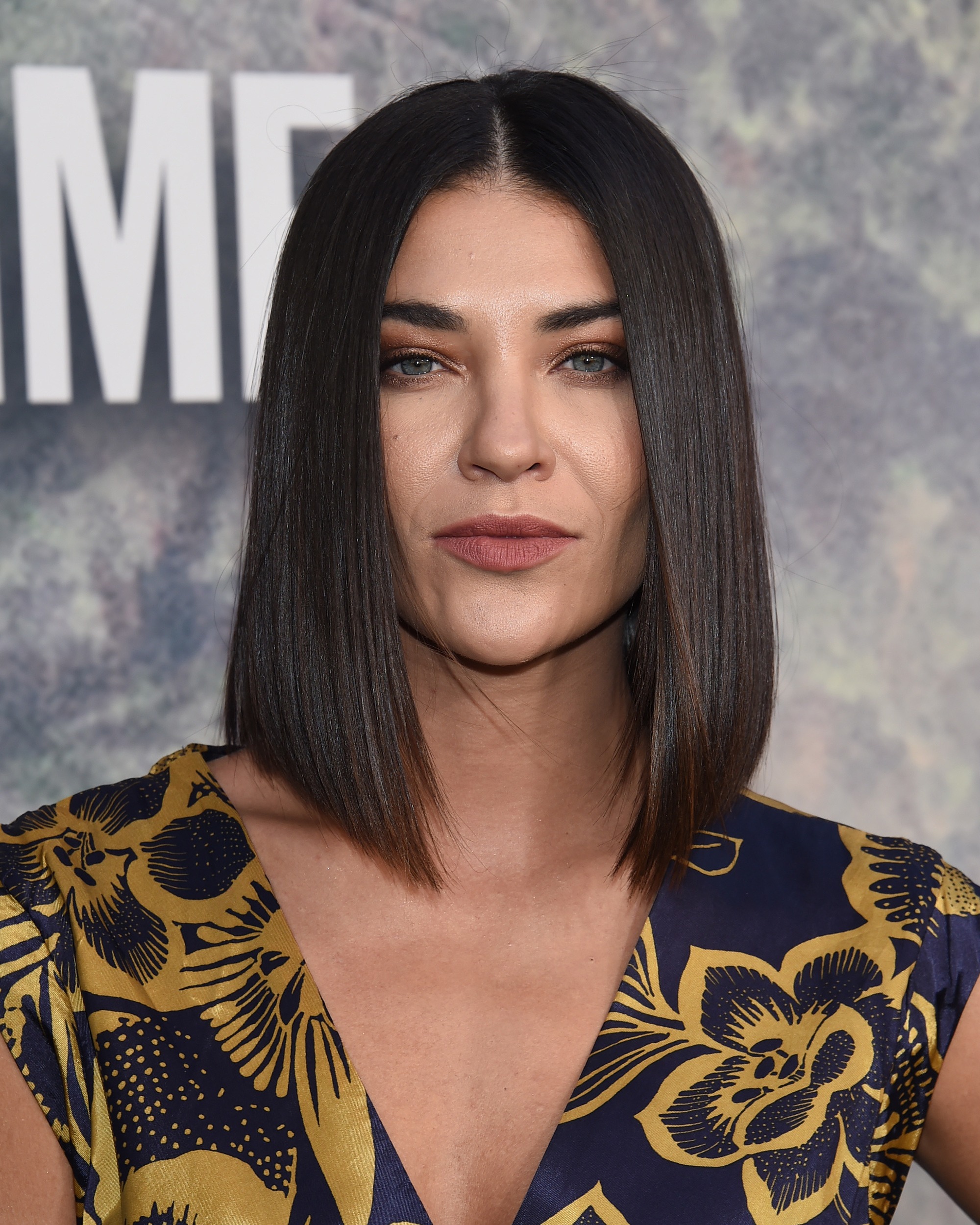 Jessica Szohr with medium dark brown hair styled into an angled blunt cut bob, wearing printed top on the red carpet