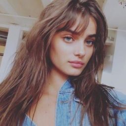 victoria's secret model taylor hill with long brunette wavy hair and birkin bangs
