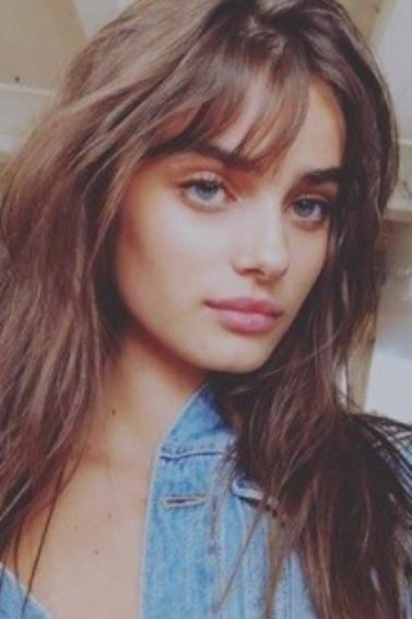 victoria's secret model taylor hill with long brunette wavy hair and birkin bangs