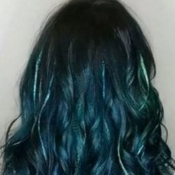 back view of emerald green wavy long hair with glitter highlights
