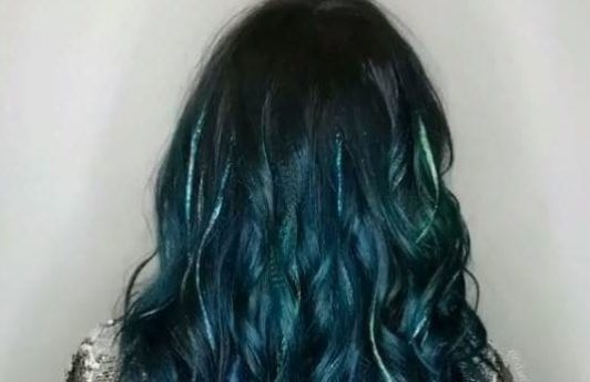back view of emerald green wavy long hair with glitter highlights