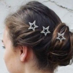 side view of a brunette woman with her hair in a twisted updo with star hair accessories