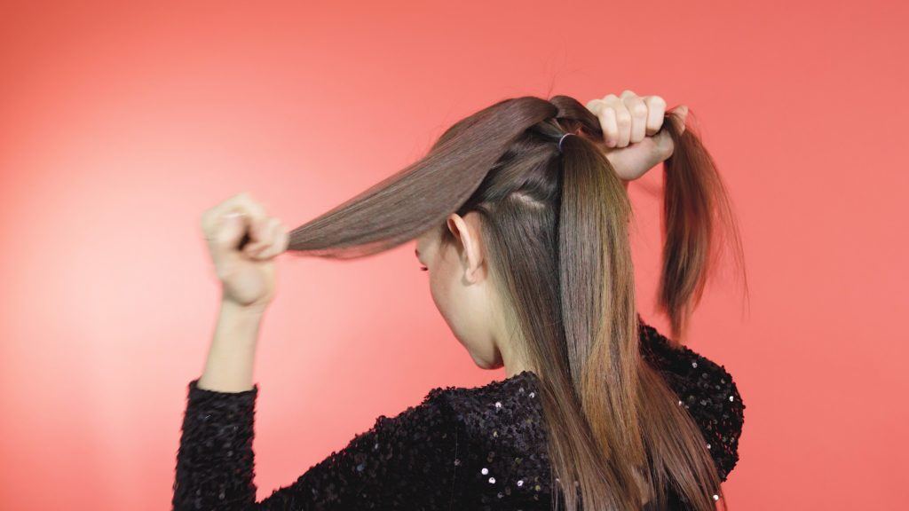 Brunette girl separating ponytail