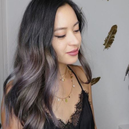 woman with long wavy dark brown ombre amethyst hair colour