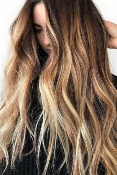woman with very long wavy brown ombre hair