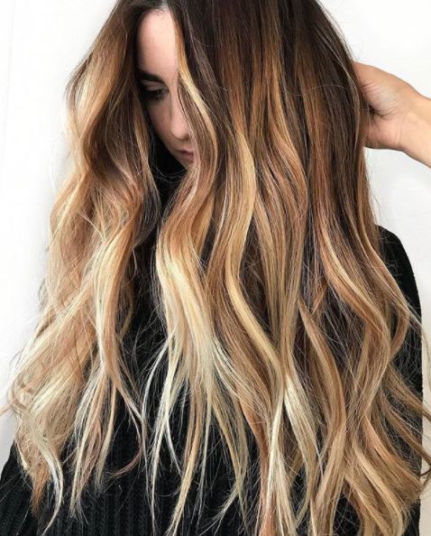 woman with very long wavy brown ombre hair
