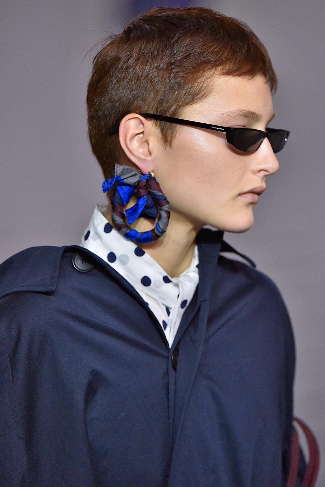 woman with short brown pixie cut and micro sunglasses