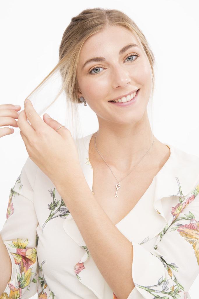 Banana bun tutorial girl pulling hair away from front of face