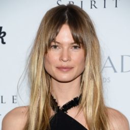 close up shot of behati prinsloo with subtle shadow roots ombre hair with bangs, wearing black dress on the red carpet
