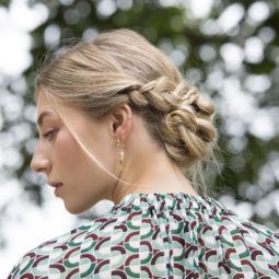 a braided chignon of a woman rear view standing outside