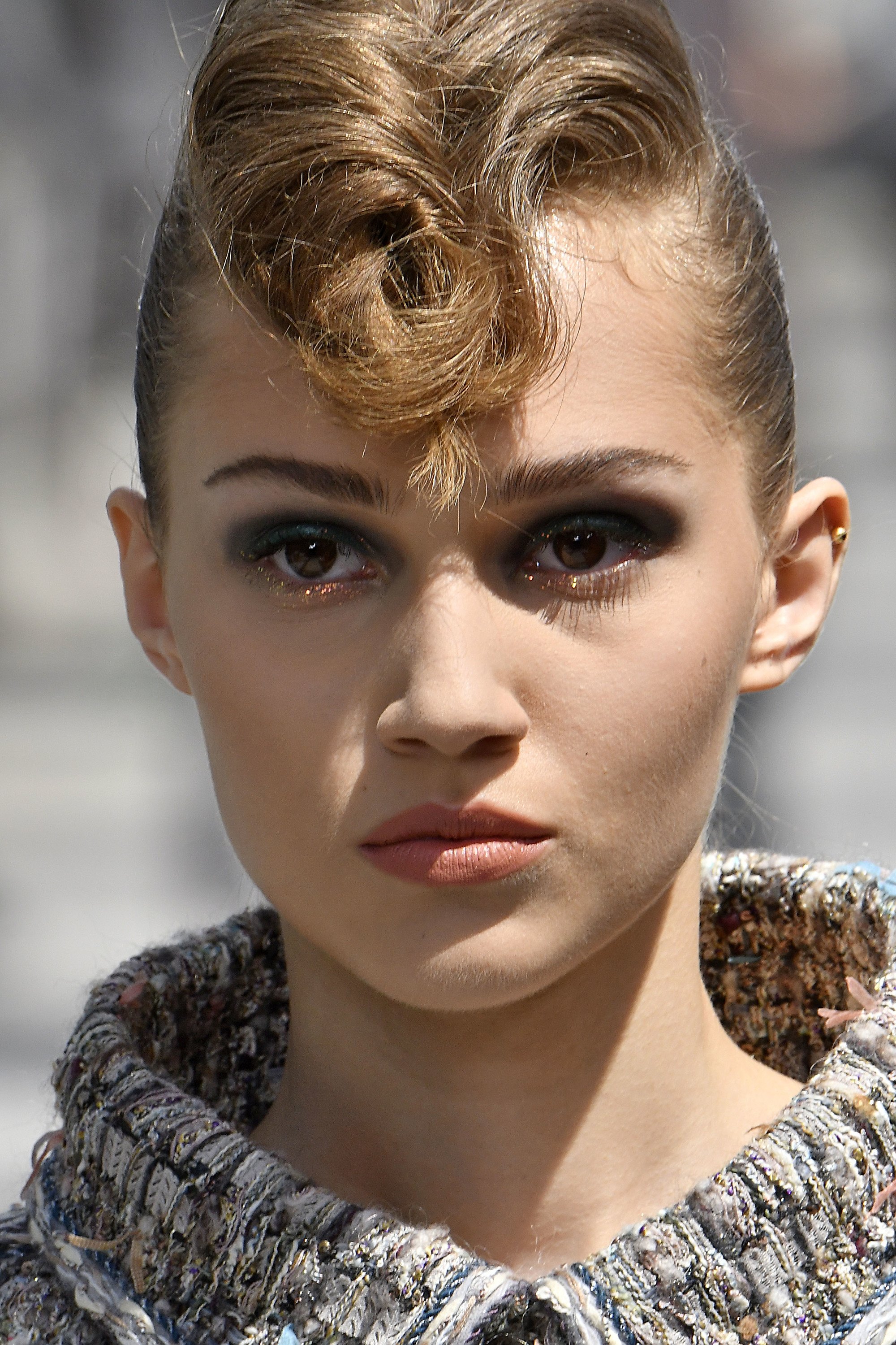 Paris Haute Couture Week fw18: close up shot of model on the chanel runway with dark blonde, medium rockabilly hair, walking down the runway