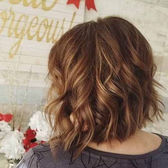 back view of a woman with a brunette bob with chocolate and caramel tones