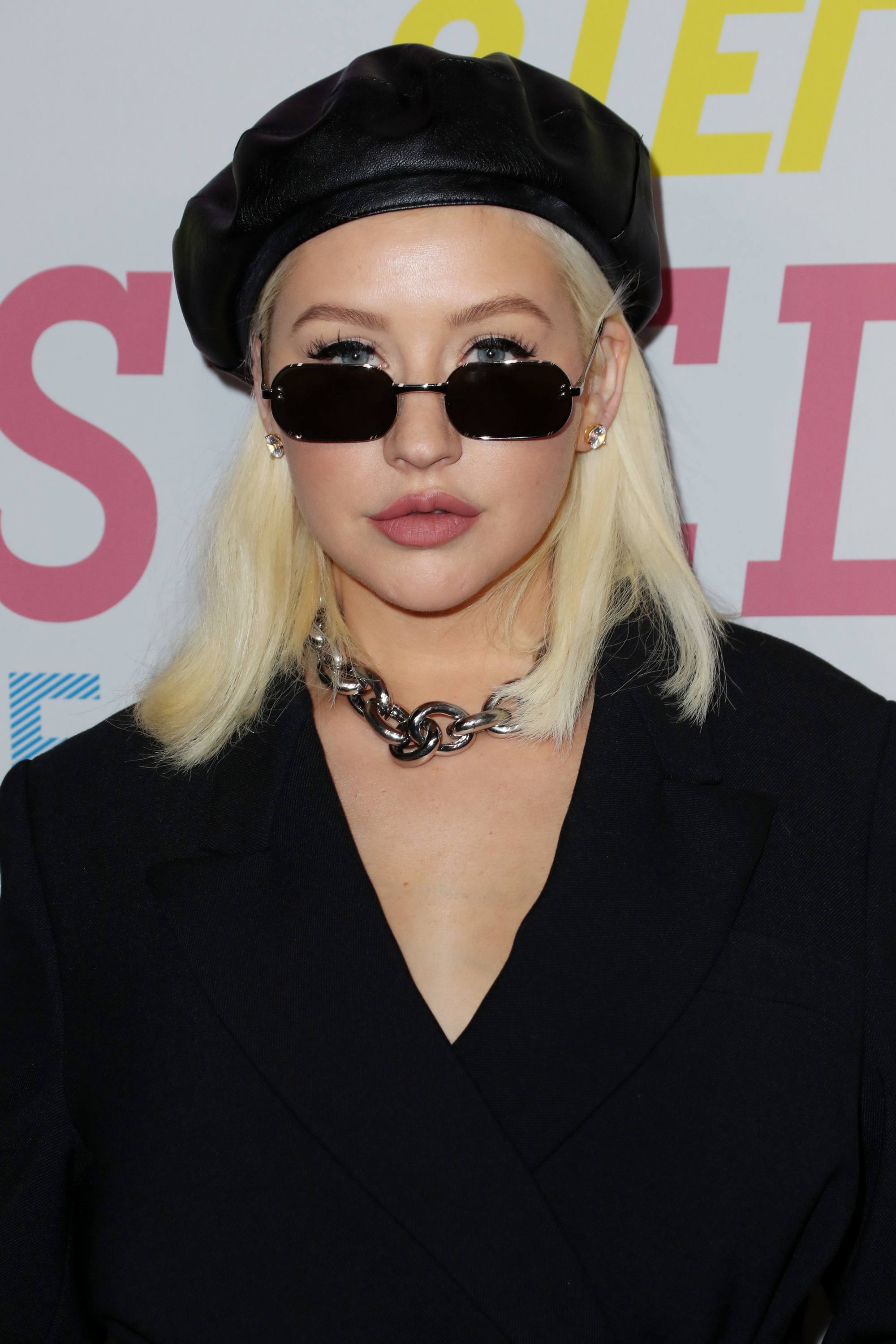 singer christina aguilera with a platinum lob and black beret hat