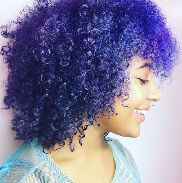 side view of purple curly shoulder length hair with curly fringe