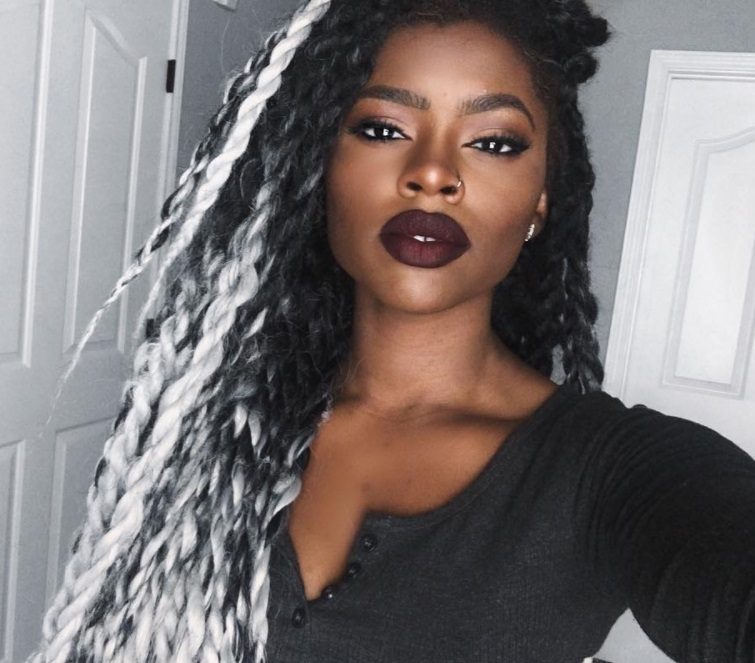 hair colour for black women: close up shot of woman with grey ombre twists, posing and wearing black top and dark lipstick