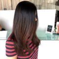 side view of woman with long dark brown ombre hair