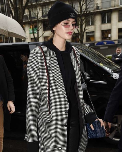 kaia gerber low ponytail wearing beanie hat and small sunglasses