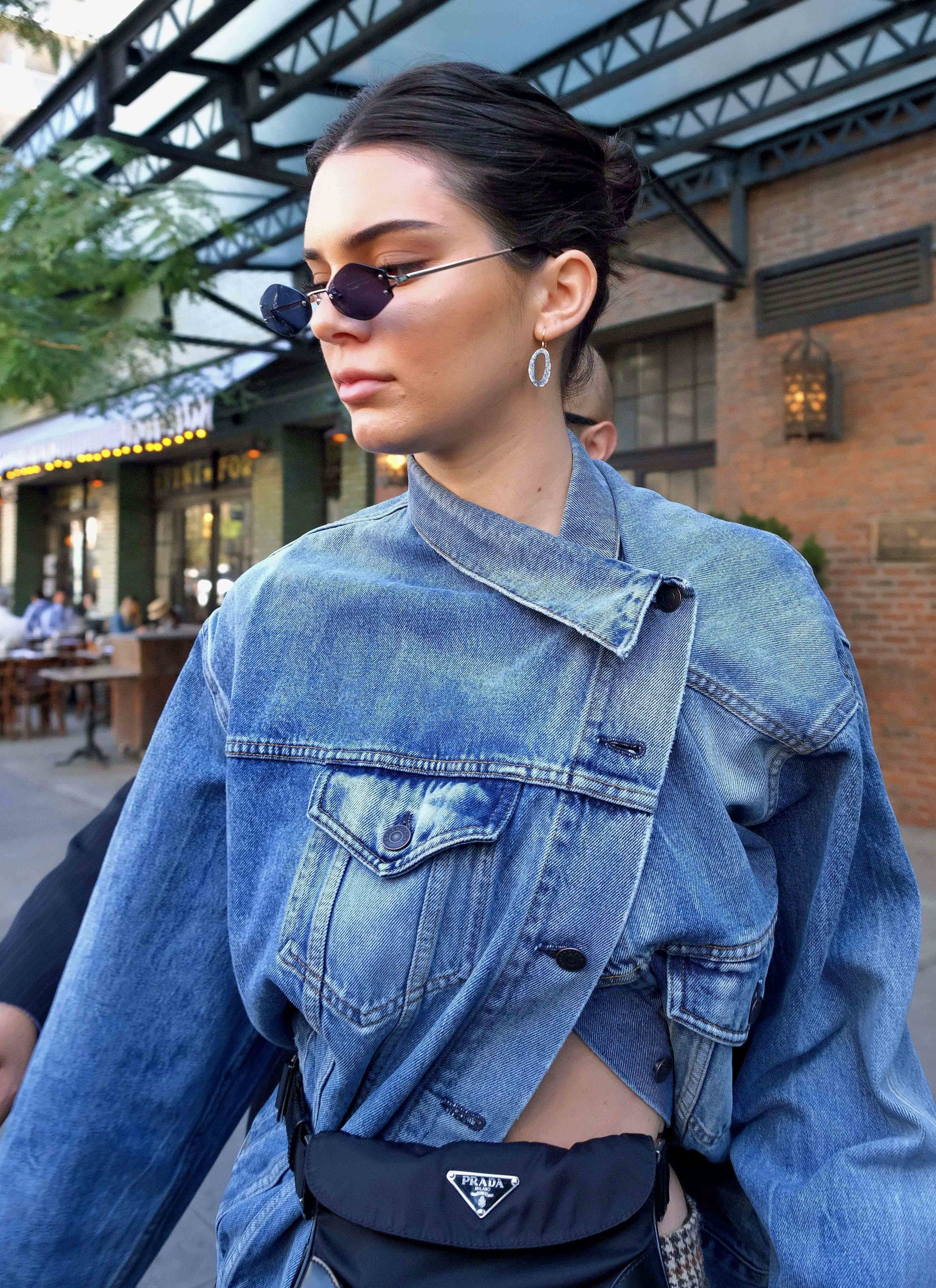 kendall ejnner dark hair in bun updo wearing micro sunglasses