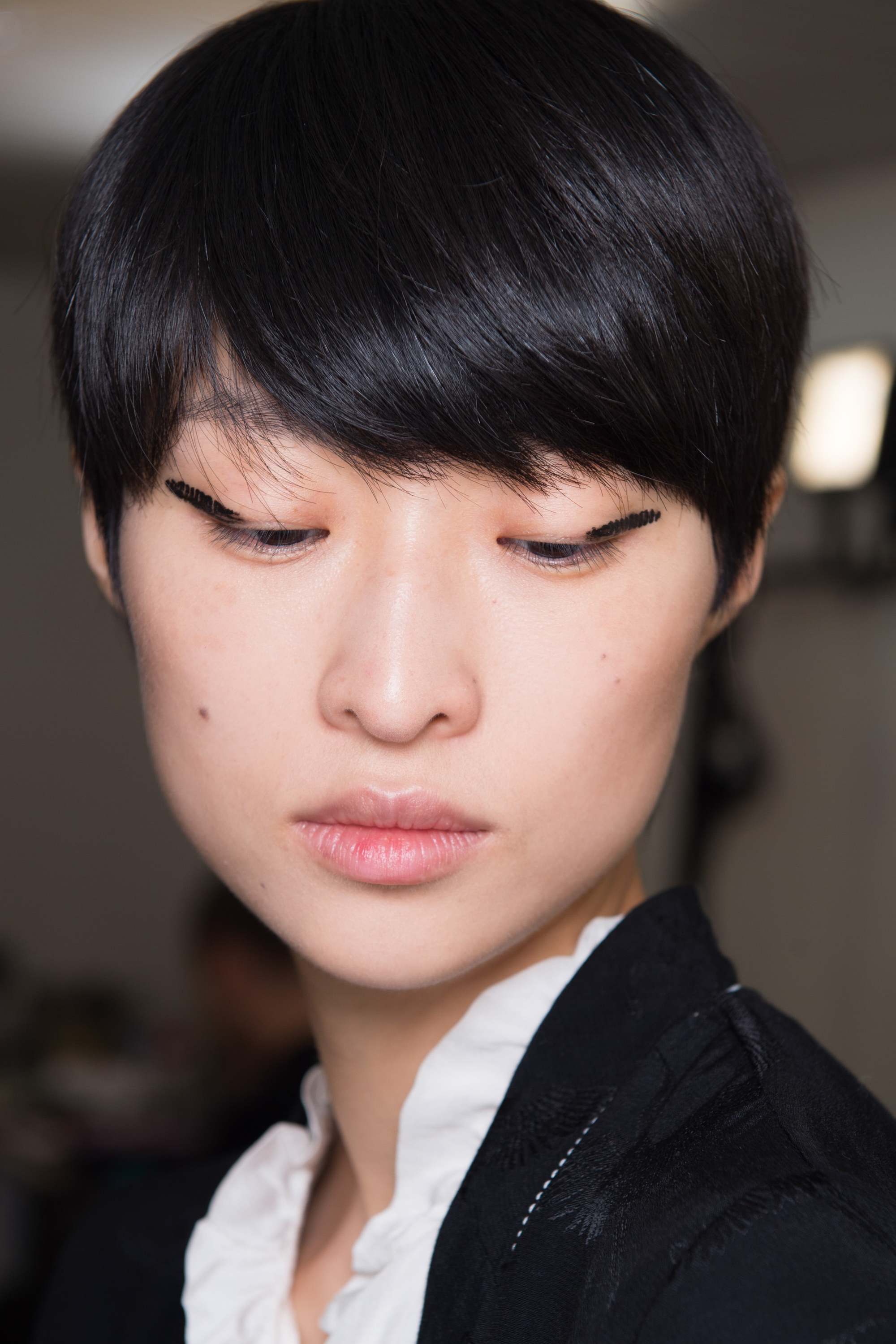 Is dry shampoo bad for your hair asian girl with short black hair backstage at Lanvin