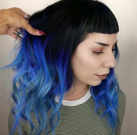 woman with dark brown hair with blue ombre finish
