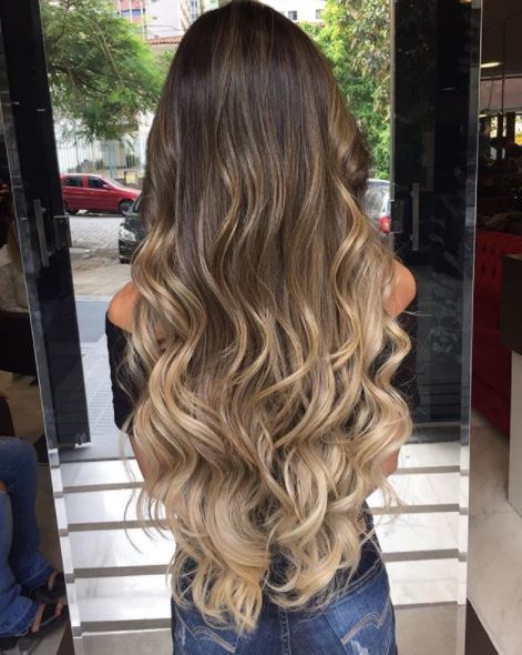 back view of woman with long brown ombre wavy hair