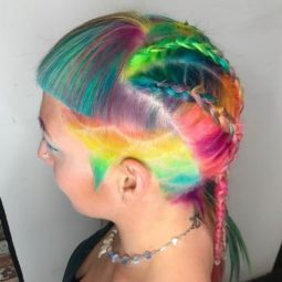 woman with a patterned undercut, micro bangs and dutch braids