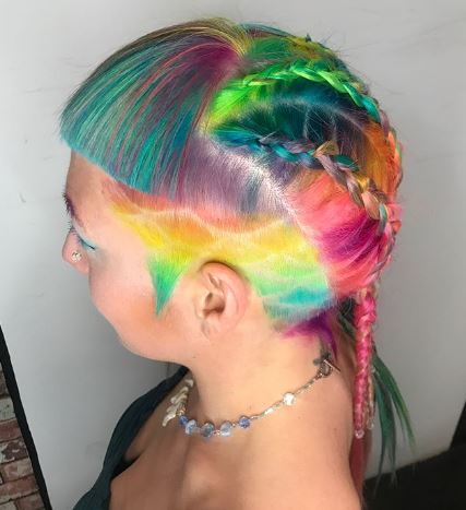 woman with a patterned undercut, micro bangs and dutch braids