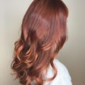 woman with long red copper ombre curly hair