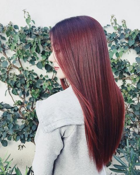 woman with long straight dark red hair