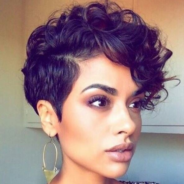 woman with medium brown curly pixie hair
