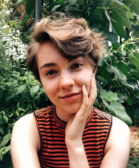 woman with brown curly pixie cut