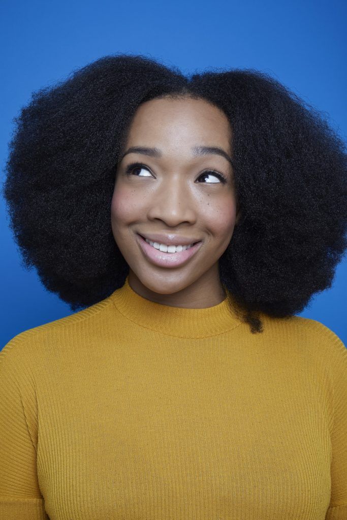 Flexi rods on natural hair girl with afro hair smiling