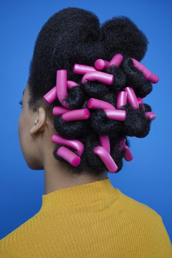 Black woman with head full of flexi rods side profile
