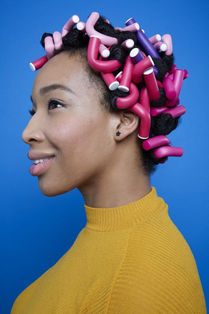 Black woman with full head of flexi rods side profile