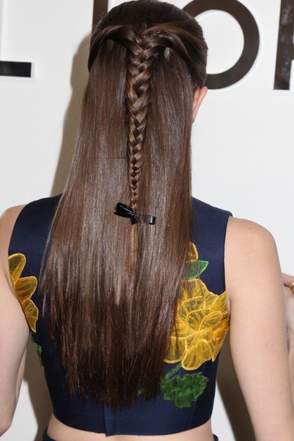 close up shot of allison williams with half up half down hairstyle with a bow on it, wearing floral dress