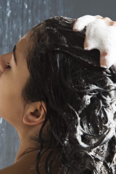 Best hair conditioner guide: Back shot of woman in the shower washing her hair