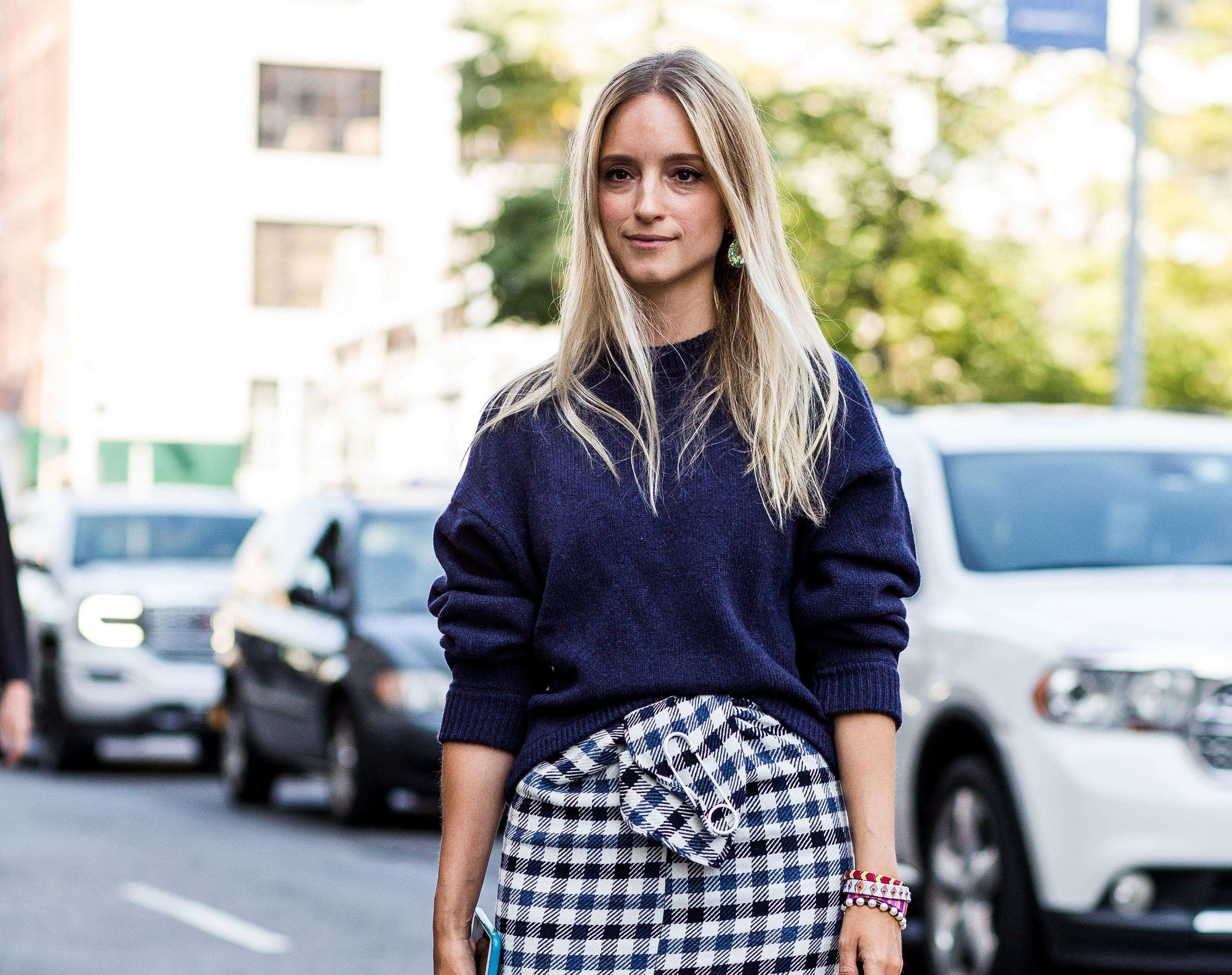 Purple conditioner for blonde hair: Blonde street style blogger with long straight hair wearing a navy jumper and checkered skirt