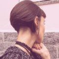 stacked bob haircuts: close up shot of woman with stacked bob and undercut hairstyles