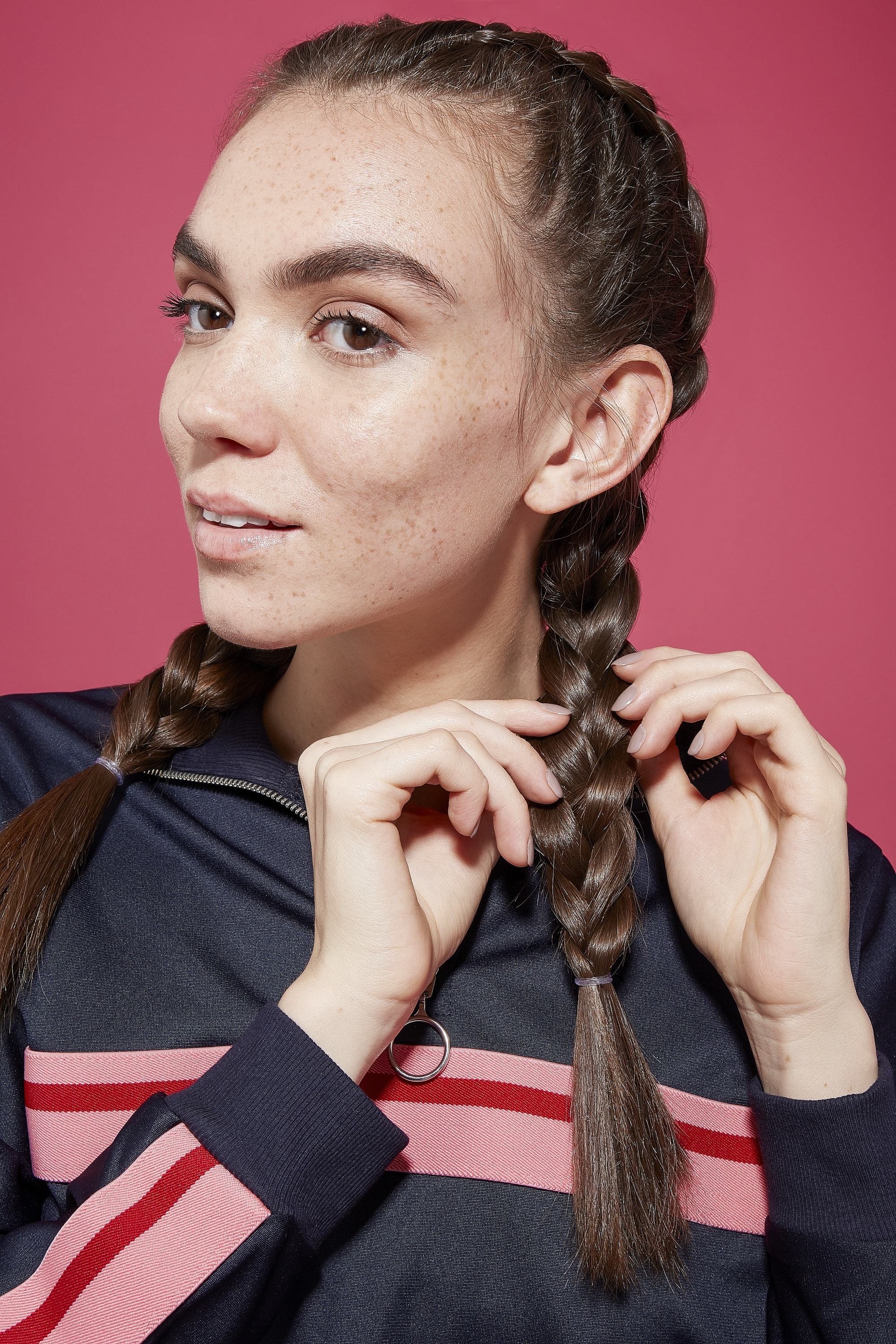 Brunette woman pulling on boxer braid from opposite sides