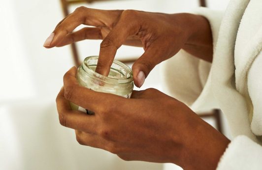 woman with coconut oil in her hand