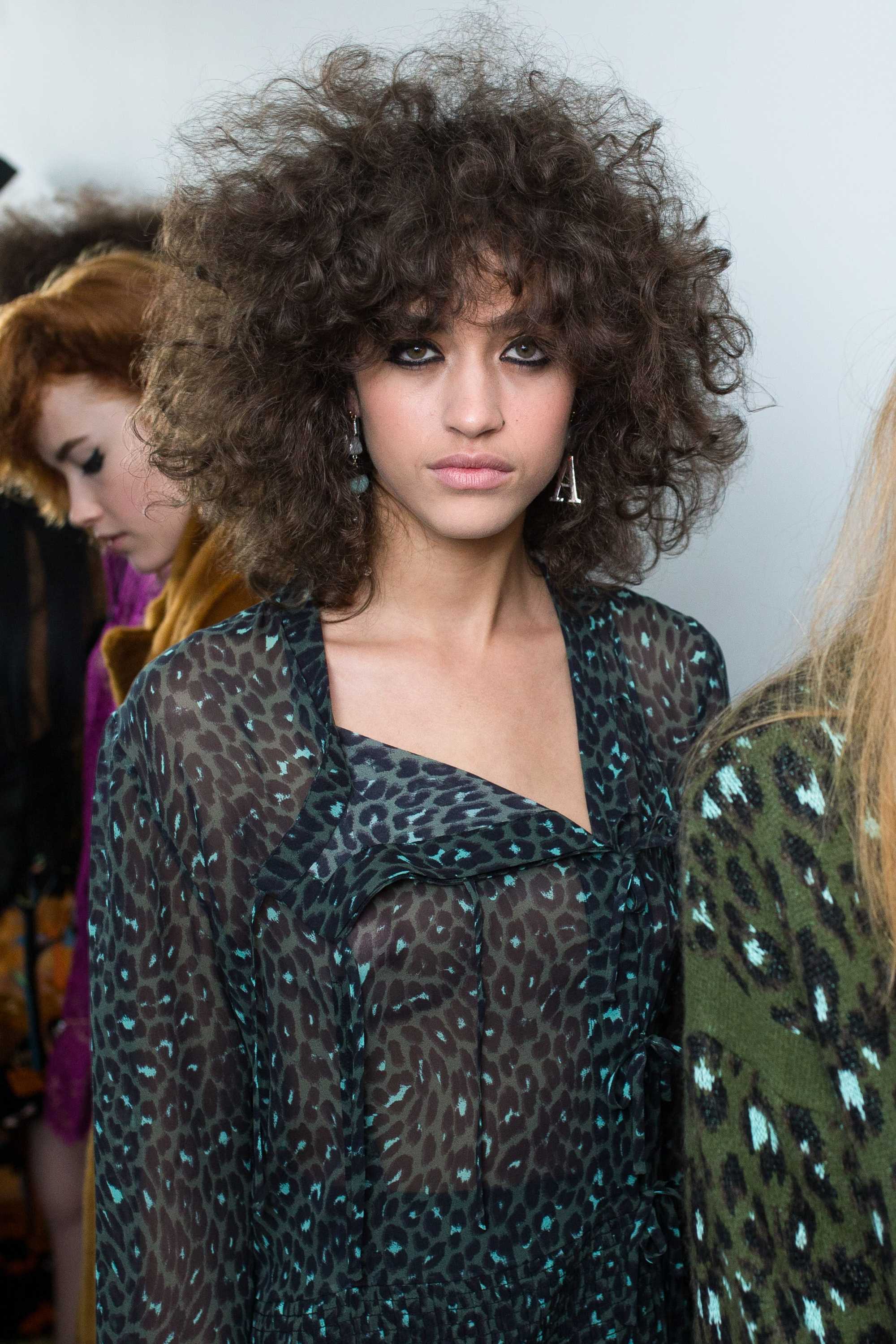 woman with long curly brunette natural hair