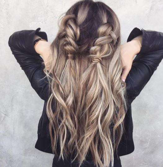 Second day hair: Woman with long dark ash blonde hair in half-up double dutch braids wearing black jacket