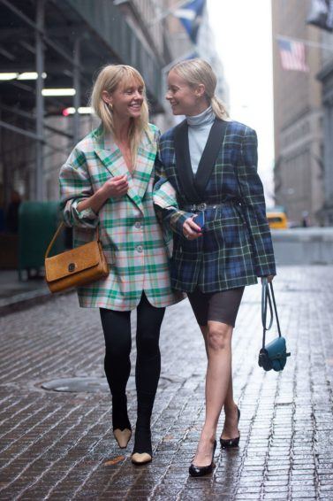 Two blonde street stylers at fashion week walking down the street
