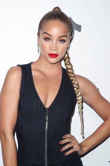 Sexy hairstyles for long hair: Jasmine Sanders with golden blonde hair in a long braid, wearing red lipstick