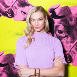 best conditioner for fine hair: close up shot of karlie kloss with wavy hair, wearing lilac jumper and posing at carolina herrera fashion show